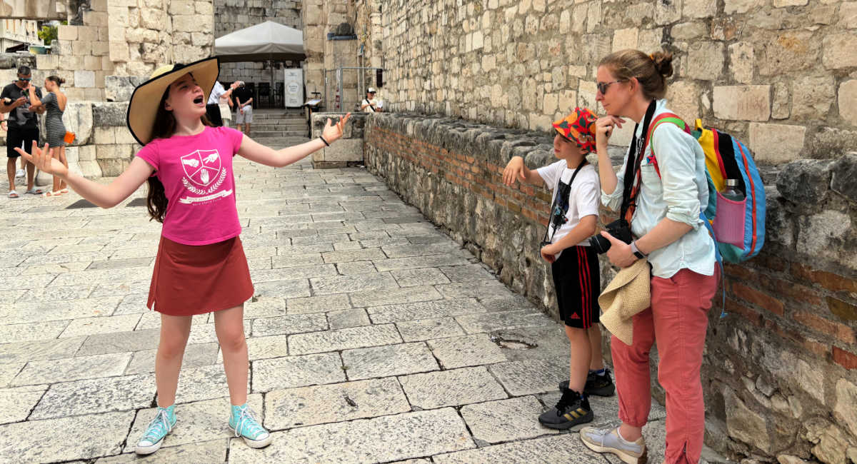 Girl singing at the Roman ruins in Pula, on Croatia family holiday