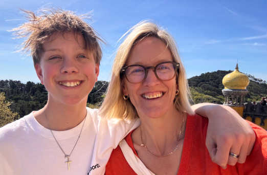 Portrait of Liddy Pleasants, MD Stubborn Mule Travel, with one of her sons, blog author