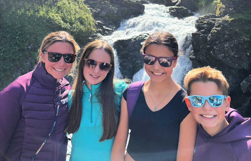 Family hiking beside waterfalls on Norway Summer itineraries