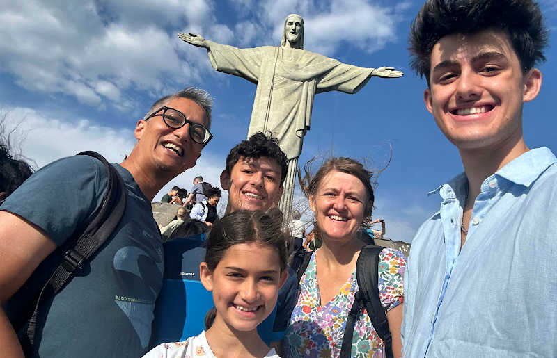 Family visiting Rio on Brazil holiday with kids, posing in front of Christ statue