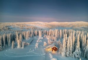 Cosy cabin in the snowy forests of Swedish Lapland