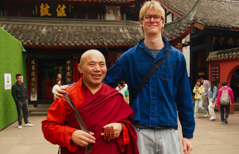Older teenager with monk in China on family holiday - China Travel Guide for families
