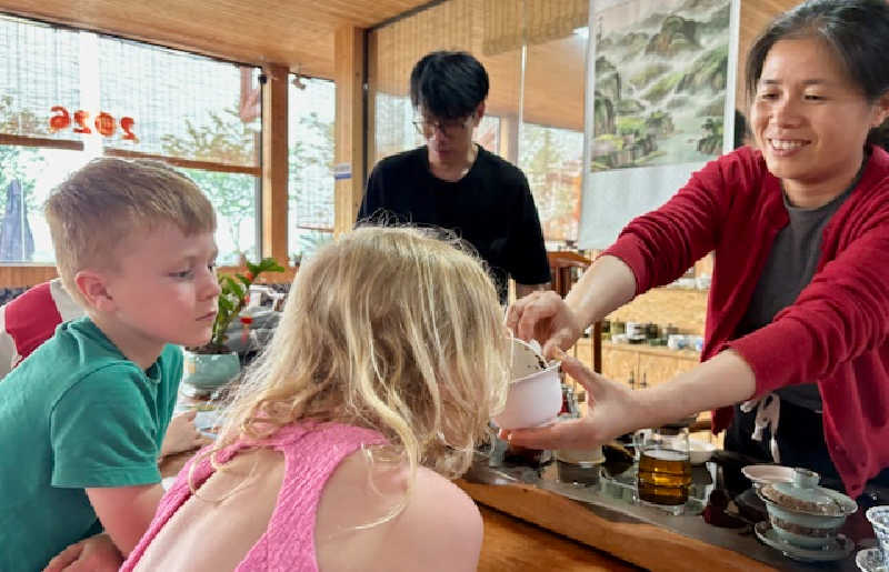 Young kids on holiday, tasting new types of food in China. Find food tips in China family travel guide
