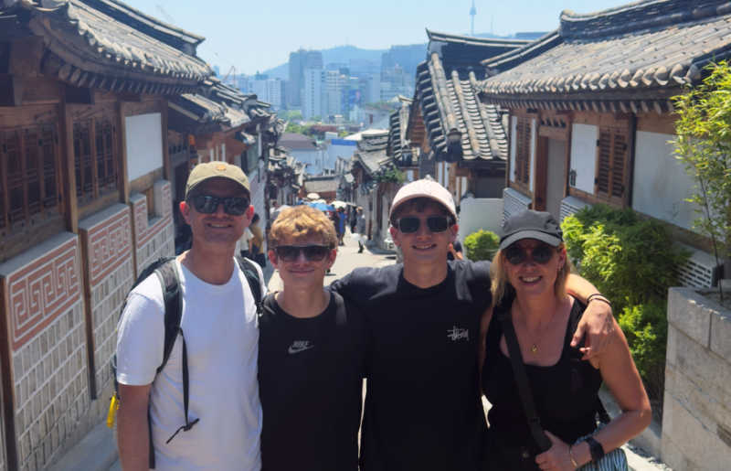 Family with teenagers on holiday in Seoul, South Korea, exploring a traditional Bukchon Hanok village