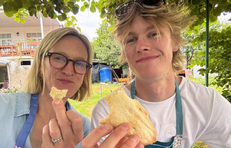 Mum and son testing out the bread they baked with a local in Georgia - Europe holidays
