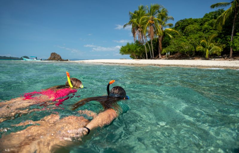 Two teenage girls snorkelling in Coiba National Park