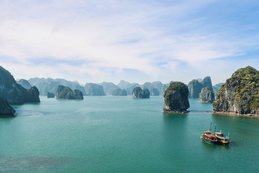 Boat sailing around Karst Island in Halong Bay
