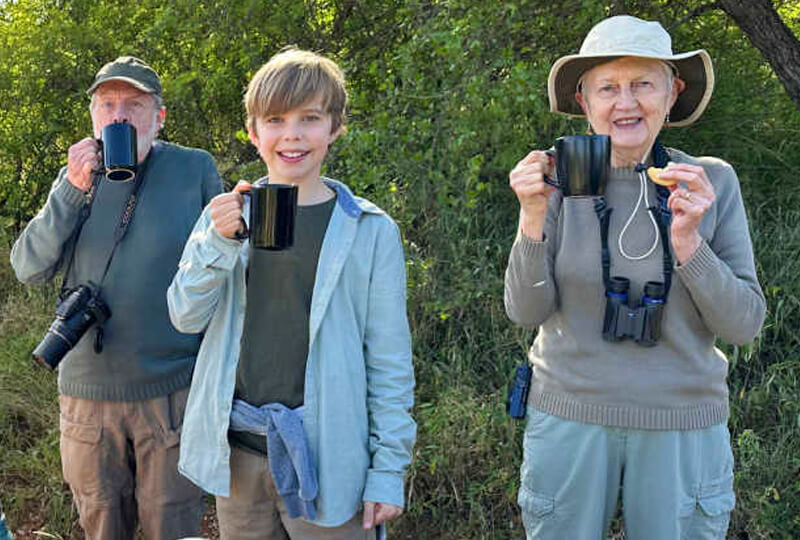 Grandparents with grandson on multi-generational safari holiday