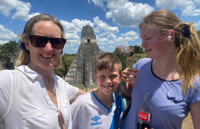 Mother with teenager and younger son, exploring Mayan ruins at Tikal, example of kids of different ages on a family holiday